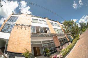 a large brick building with a sign on it at Llanogrande Airport by Bernalo Hotels in Rionegro