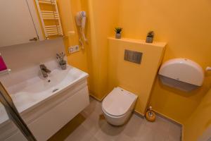a bathroom with a white toilet and a sink at New Gudauri, Loft 1, #114, Cosy Apartment -Gondola lift in Gudauri +25 photos