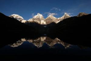 a reflection of a snow covered mountain in the water at Amaru Hotel Huaraz in Huaraz