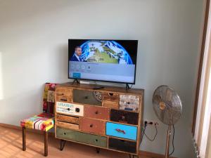 a flat screen tv sitting on top of a dresser at Apartment Mischa in Innsbruck