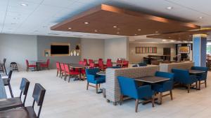 a dining room with tables and chairs and a cafeteria at Holiday Inn Express & Suites - Tampa East - Ybor City, an IHG Hotel in Tampa