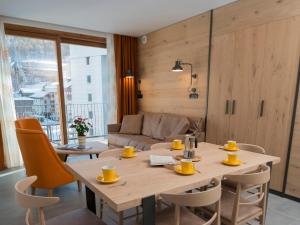 a dining room with a table and a couch at Red Fox Lodge in Breuil-Cervinia