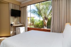 
A bed or beds in a room at Costa do Sol Boutique Hotel
