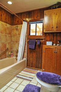 a bathroom with a tub and a toilet and a sink at Heart and Wings Retreat Center in Silver City