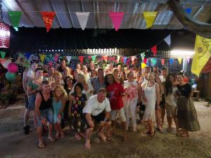 a group of people posing for a picture at a party at PP Red Tuna Hut in Phi Phi Islands