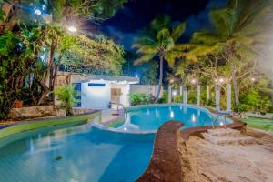 a swimming pool in a resort at night at Private Villa 10 Rooms, Private Pool, Walk to Beach in Playa del Carmen