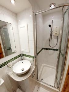 a bathroom with a sink and a shower at Chelmsford Centre House in Chelmsford