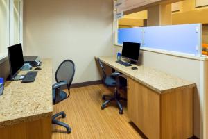 an office cubicle with two desks with two computers at Holiday Inn Express Hotel and Suites - Henderson, an IHG Hotel in Las Vegas