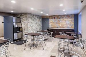 a restaurant with tables and chairs and a refrigerator at Umbrella Hotel Brooklyn in Brooklyn