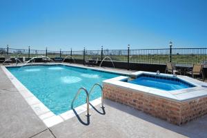 a large swimming pool with a brick wall at Holiday Inn Express Hotel and Suites Monahans I-20, an IHG Hotel in Monahans