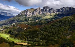 a view of a mountain range with trees and mountains at Hotel Lena in Pola de Lena