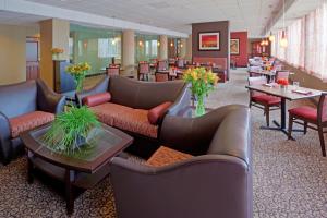 a hotel lobby with couches and tables and chairs at Holiday Inn Portsmouth by IHG in Portsmouth