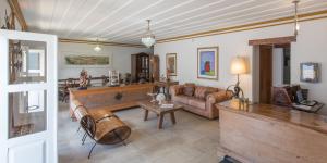 a living room with a couch and a table at Pousada do Douro in Ouro Preto +12 photos