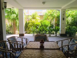 a table and chairs on a patio with plants at Guest House Barbov in Obzor