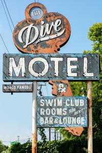 an old sign for the blue morrier with a sign for a restaurant at The Dive Motel and Swim Club in Nashville