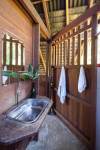 a bathroom with a sink in a cabin at La Kuka Hotel - Nuquí in Nuquí