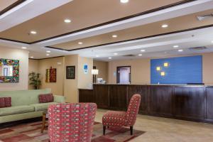 a waiting room with a couch and a large screen at Holiday Inn Express Hartford-Newington, an IHG Hotel in Newington