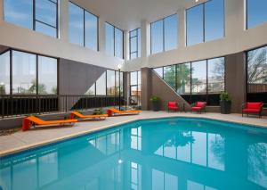 a swimming pool in a building with windows at Crowne Plaza Dallas Love Field - Med Area, an IHG Hotel in Dallas