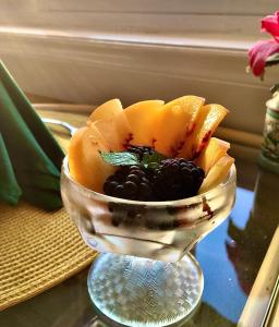 a bowl filled with fruit on top of a table at Friendly City Inn B&B in Harrisonburg