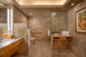 a bathroom with a shower and a toilet and a sink at Four Seasons Hotel New York in New York