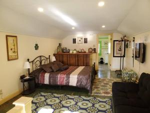 a bedroom with a bed and a living room at Natalie House in Boston