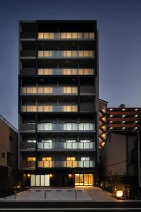 a tall building with many windows in a parking lot at Marina Sunrise Osaka Bay in Osaka