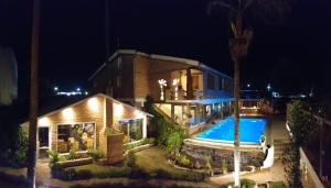 a house with a swimming pool at night at Los Brunos Posada in Reconquista