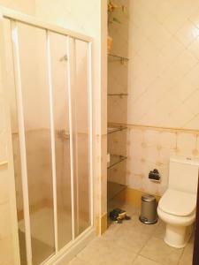 a bathroom with a shower and a toilet at Samsara Home in Caleta de Sebo