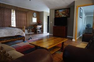 a living room with a bed and a wooden table at A&A Lake Tahoe Inn in South Lake Tahoe