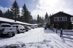 a parking lot covered in snow next to a house at A&A Lake Tahoe Inn in South Lake Tahoe