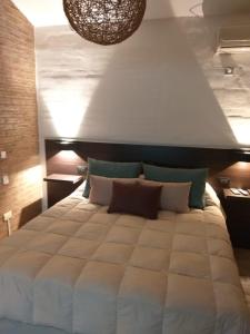 a bedroom with a large bed with a large white comforter at Finca El Amparo in Los Reartes