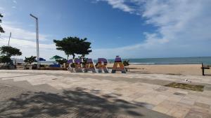 a group of chairs sitting on the beach at APTO LUXO EM HOTEL - BEIRA MAR FORTALEZA in Fortaleza