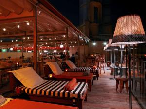 a patio with couches and tables and a lamp at Mama Shelter Bordeaux Centre in Bordeaux