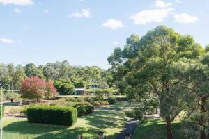 a view of a park with trees and grass at Urban Escape - Parramatta in Sydney