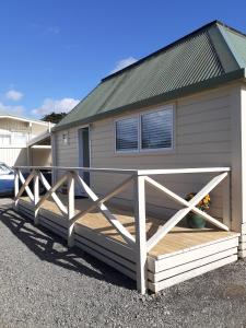a house with a wooden fence in front of it at Featherston Motels And Camping in Featherston
