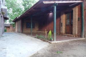 a brick house with a large patio in front of it at Terra II in Villa Carlos Paz