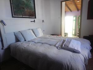 Ένα ή περισσότερα κρεβάτια σε δωμάτιο στο The Violet House muy cerca del Aeropuerto Tenerife Norte