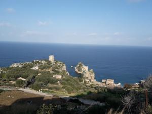 an island in the ocean with a castle on it at Casolare La Torre in Scopello