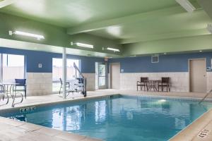 a large swimming pool with chairs and a table at Holiday Inn Express & Suites - Prosser - Yakima Valley Wine, an IHG Hotel in Prosser