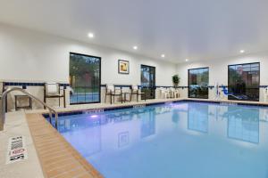 a large pool with blue water in a hotel at Holiday Inn Express I-95 Capitol Beltway - Largo, an IHG Hotel in Largo