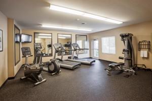 a gym with treadmills and machines in a room at Candlewood Suites Oklahoma City - Bricktown, an IHG Hotel in Oklahoma City