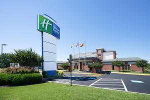 a sign in a parking lot in front of a hotel at Holiday Inn Express Cambridge, an IHG Hotel in Cambridge