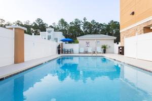 a swimming pool with blue water in a building at Holiday Inn Express & Suites., an IHG Hotel in Fleming Island