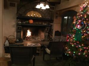 a christmas tree in a living room with a fireplace at Les Artistes Inn in San Diego