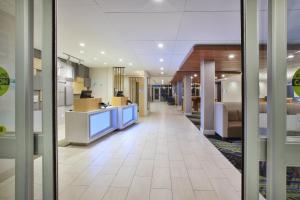 a hallway of an office building with a lobby at Holiday Inn Express & Suites Grand Rapids Airport North by IHG in Grand Rapids +28 photos