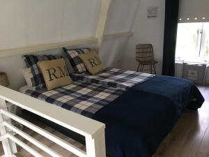 a bed with two pillows on it in a bedroom at Summerhouse Zandvoort in Zandvoort