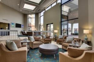 a lobby with chairs and tables and windows at Candlewood Suites - Wichita East, an IHG Hotel in Wichita