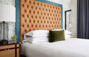 a bedroom with a large bed with a large headboard at Kimpton Hotel Monaco Denver by IHG in Denver