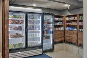 an open refrigerator in a kitchen with shelves full of food at Holiday Inn Express Santa Rosa, an IHG Hotel in Santa Rosa