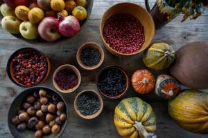 a table topped with bowls of fruits and vegetables at Agro Guesthouse Korena in Kutaisi